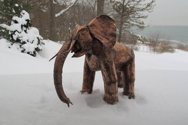 Copper Sculpture of elephant in snowy forest