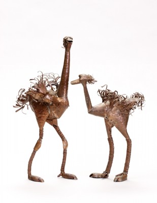 pair of copper ostrich sculptures on white background